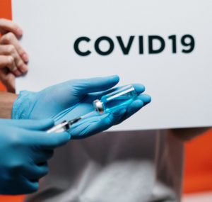 Hand holding a Covid-19 vaccine